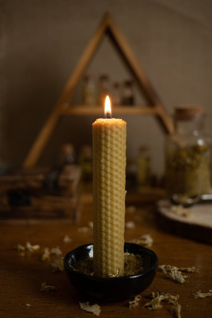 Elegant still life featuring a burning beeswax candle, creating a warm ambiance.